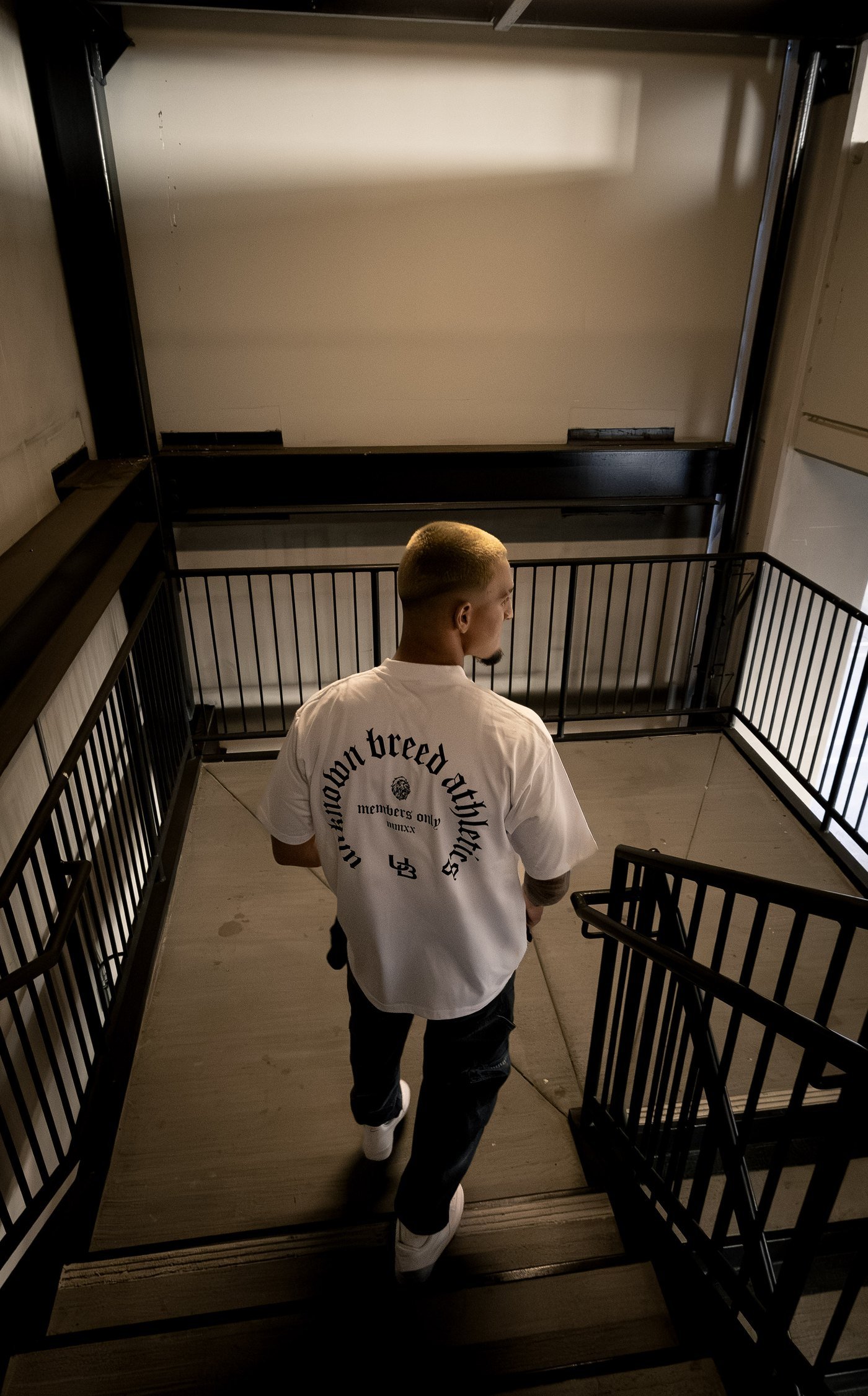 Back print of the Members Only Tee in a stairwell